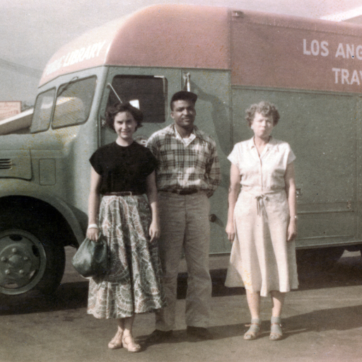 Three people in front of a Library Bookmobile, circa 1950.