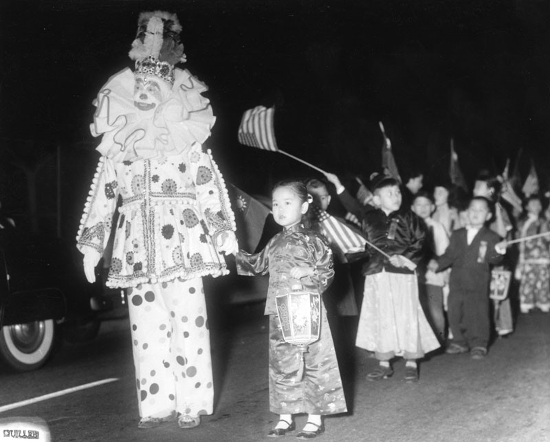 Wally the Clown leads children at a New Year festival in Chinatown.