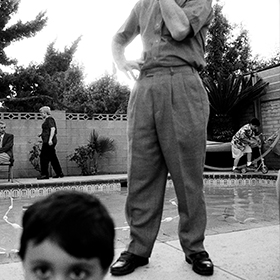 black and white photo of family around backyard pool