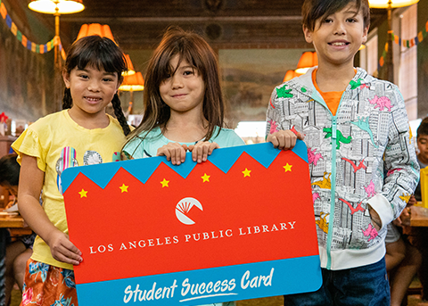 three kids hold a huge student success card