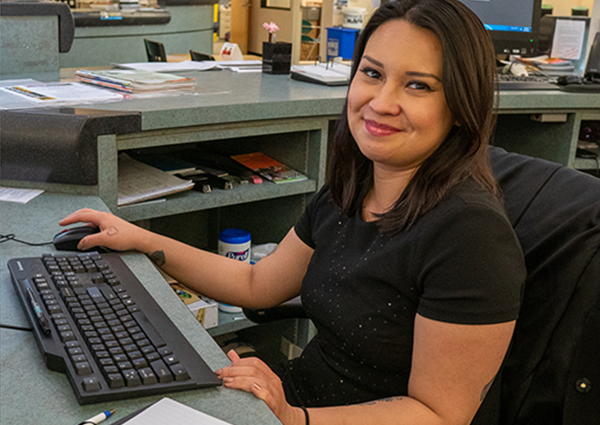 cybernaut sitting at her computer waiting to help patrons