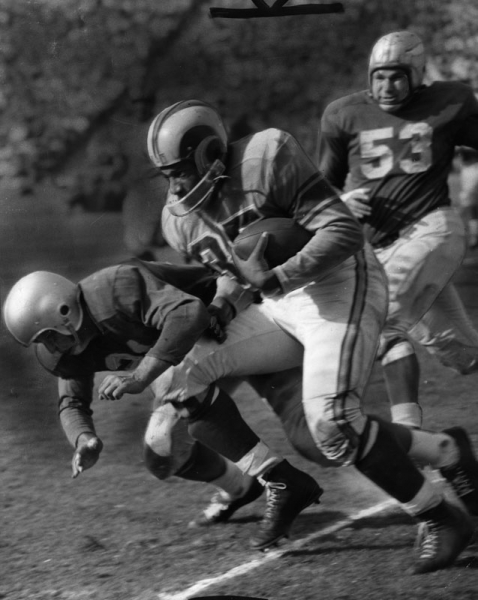 Tank Younger carries the ball for the Los Angeles Rams.