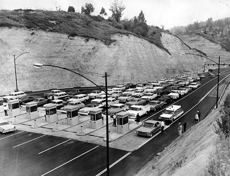 auto lineup of anxious baseball fans waiting at Solano Street entrance to new Dodger Stadium