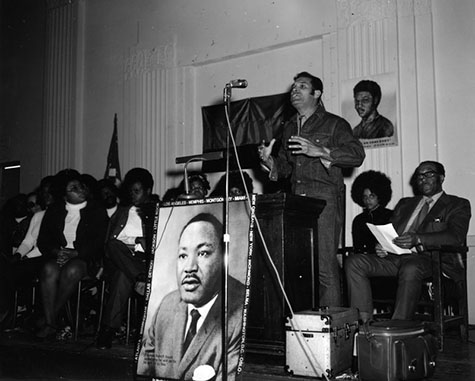 Group photo of supporters of Operation Breadbasket. At the podium is City Council member Billy Mills.