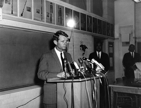 Attorney General Robert Kennedy holds a press conference in the choral room at Markham Junior High School in the Watts neighborhood.