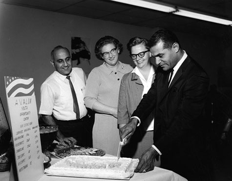 Leaders of Avalon Youth Opportunity Center celebrate a second year in 1968. Harry Halbandian is director, and City Council member Billy Mills cuts a cake. 