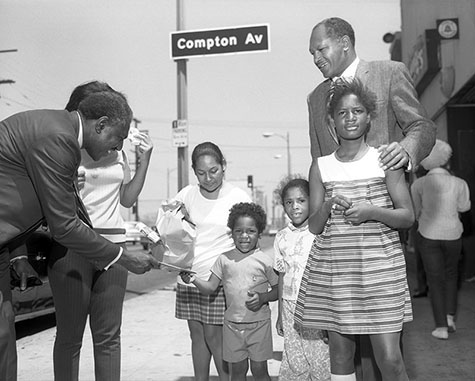 Wilson Riles campaigns for California State Superintendent of Public Instruction with Councilman Tom Bradley outside of Magnificent Bros Hair Salon 2, located at 1568 E. 103rd Street in Watts. 