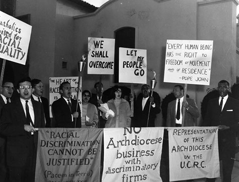 Members of Catholics United for Racial Equality (CURE) rally against racial discrimination by the Catholic Church. 