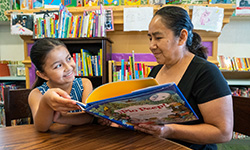 Grandmother reading to grand daughter