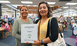 Two women with Leamos binder