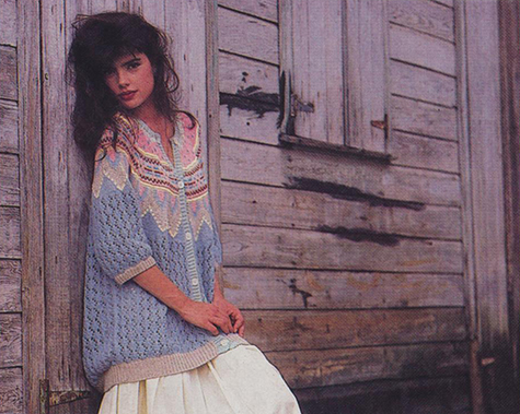 women leaning on weather wood fence in ugly sweater