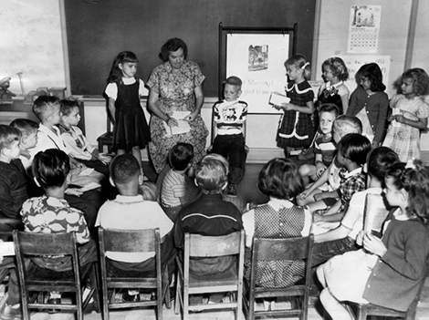 , first grade pupils of Hoover Street School gathered around their teacher, Miss Martha Ingram