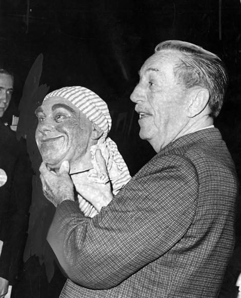 Walt Disney holds one of the pirate heads