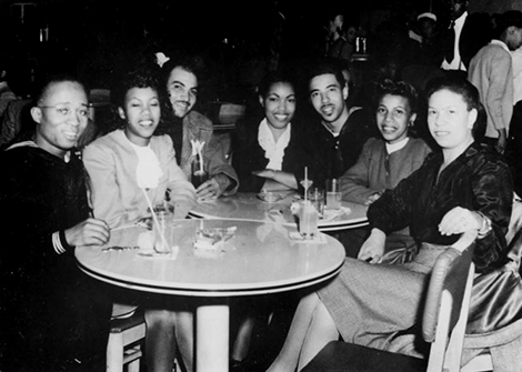 A group of women enjoy jazz in the company of a group of sailors