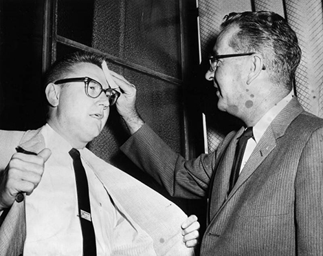 man swabbing forehead of another man