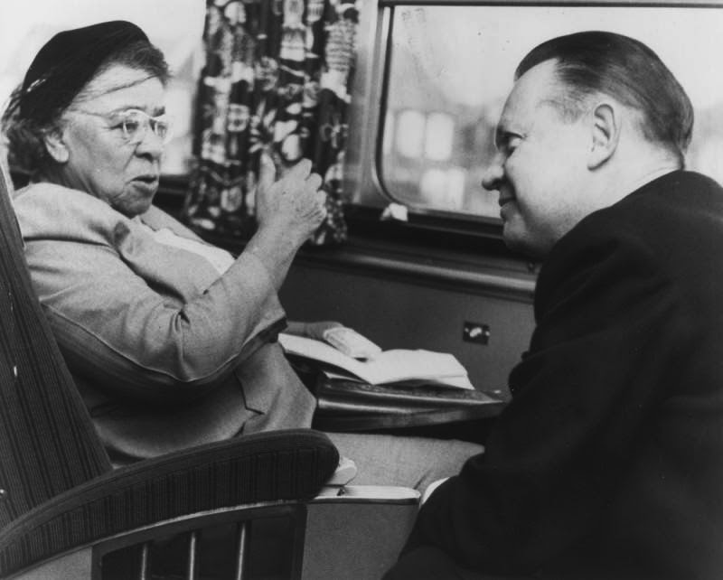 Charlotta speaking to an unidentified man