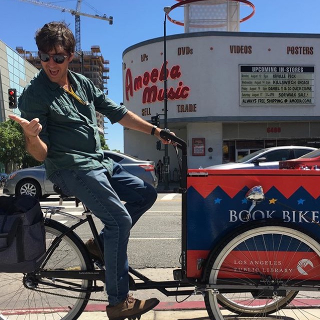 Daniel Tures on the LAPL Bike in front of Amoeba Records