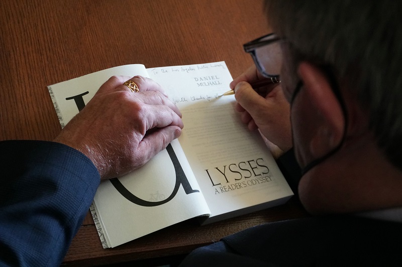 Daniel Mulhall, Ambassador of Ireland signing a book