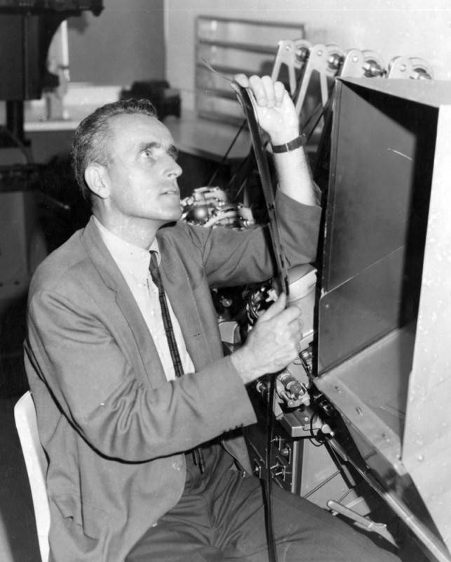 Filmmaker Dr. Edmund Carpenter checks the condition and content of a filmstrip in 1963