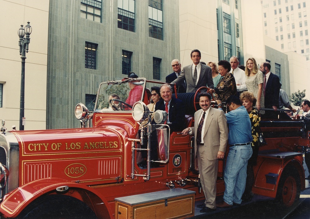 Mayor Riordan on an old fashioned Fire Truck in front of the library