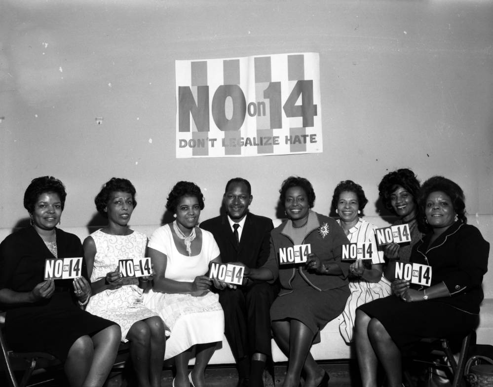 Tom Bradley poses with seven women