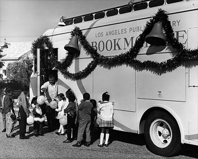 Bert Thomas and his bookmobile decorated for the holidays