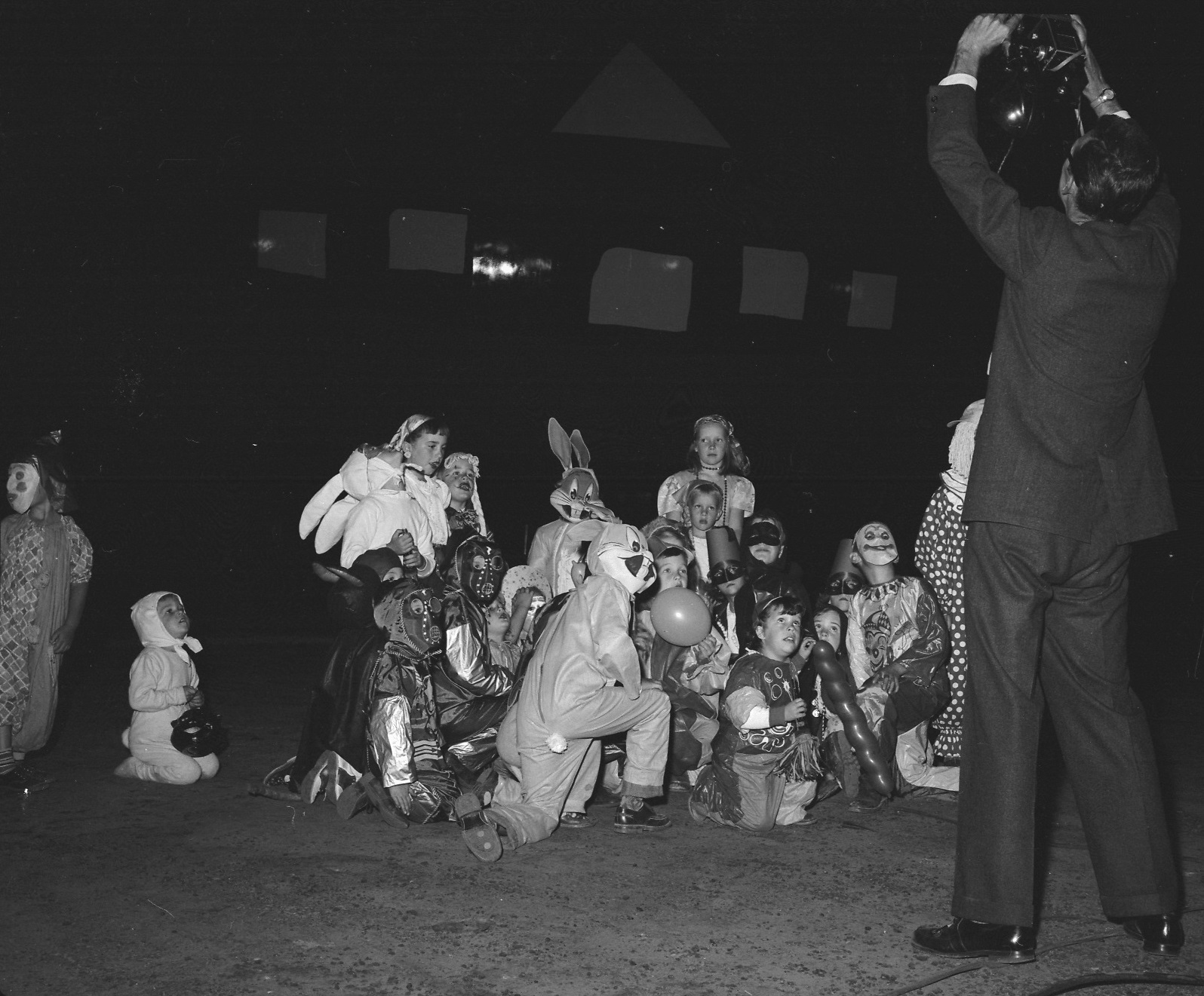 Children gathered around Smiling Jack ca. 1954