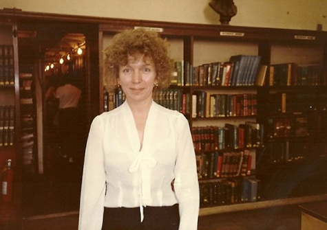 Chris Bocek in the Literature Dept., behind her are the stacks where the fire broke out
