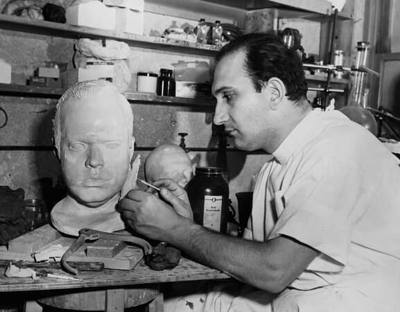 artist sculpts head of man