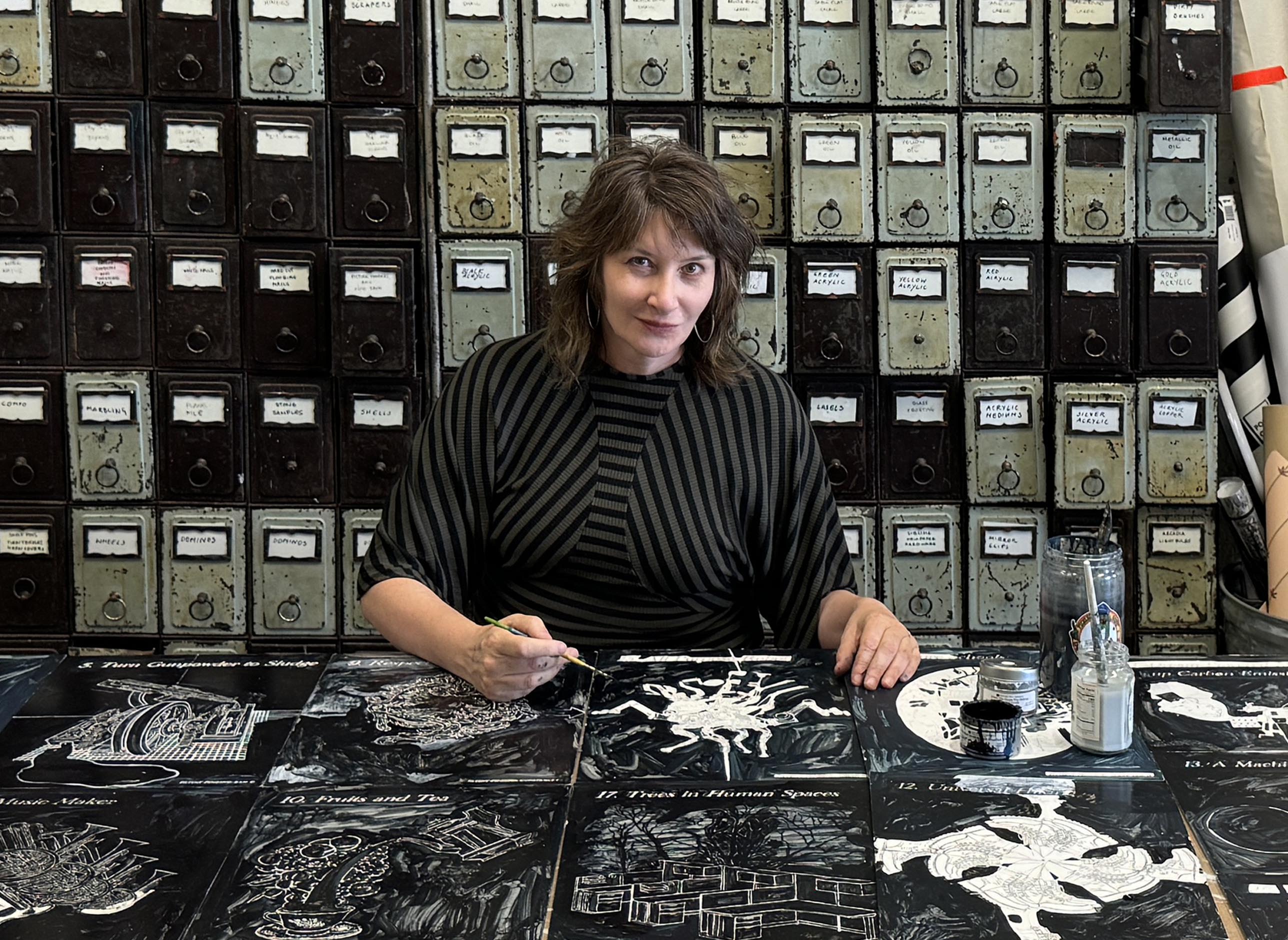 Artist Ellen Harvey painting