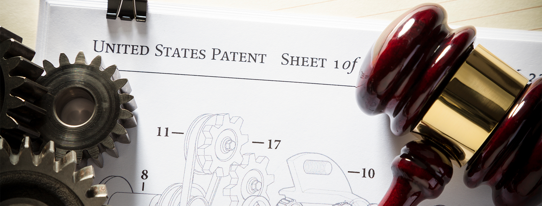gears, patent paper work, and gavel representing patents