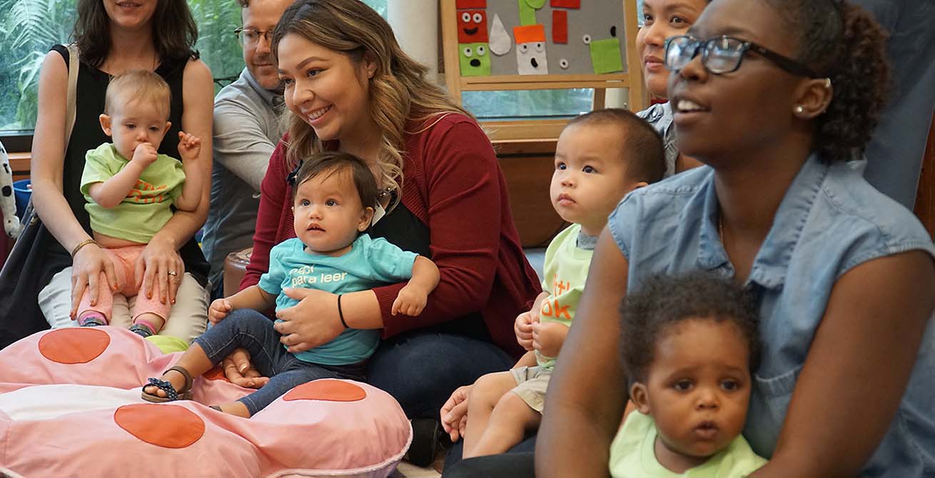 a large group of babies and their parents