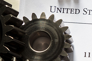 gears with paper work in the background representing patents