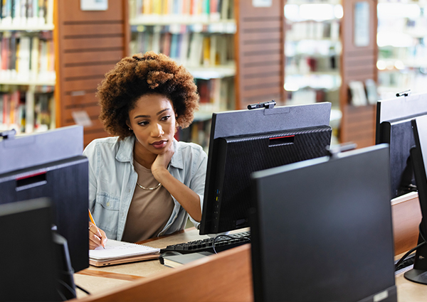 woman using library desktop computer