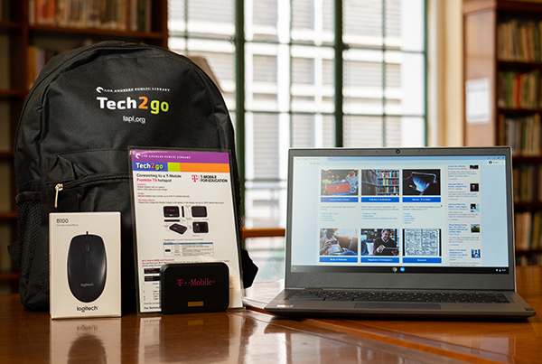 Items in a computer bundle including a Chromebook, a hotspot, a computer mouse, and a black backpack.