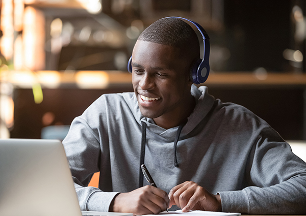 Man on laptop smiling.