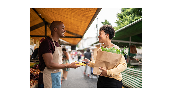 an outdoor vendor finalizing a sale with a customer