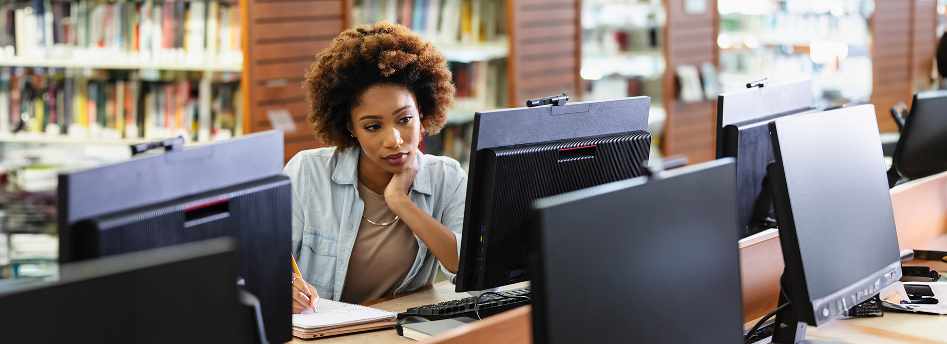 a woman sitting in front of a computer